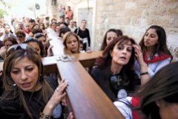 Proudly shouldering the religious symbol of a wooden cross, Arab Catholic Scouts participate in The Stations of the Cross procession for Catholic Easter in the Old City of Jerusalem, Israel on March 21, 2008.
